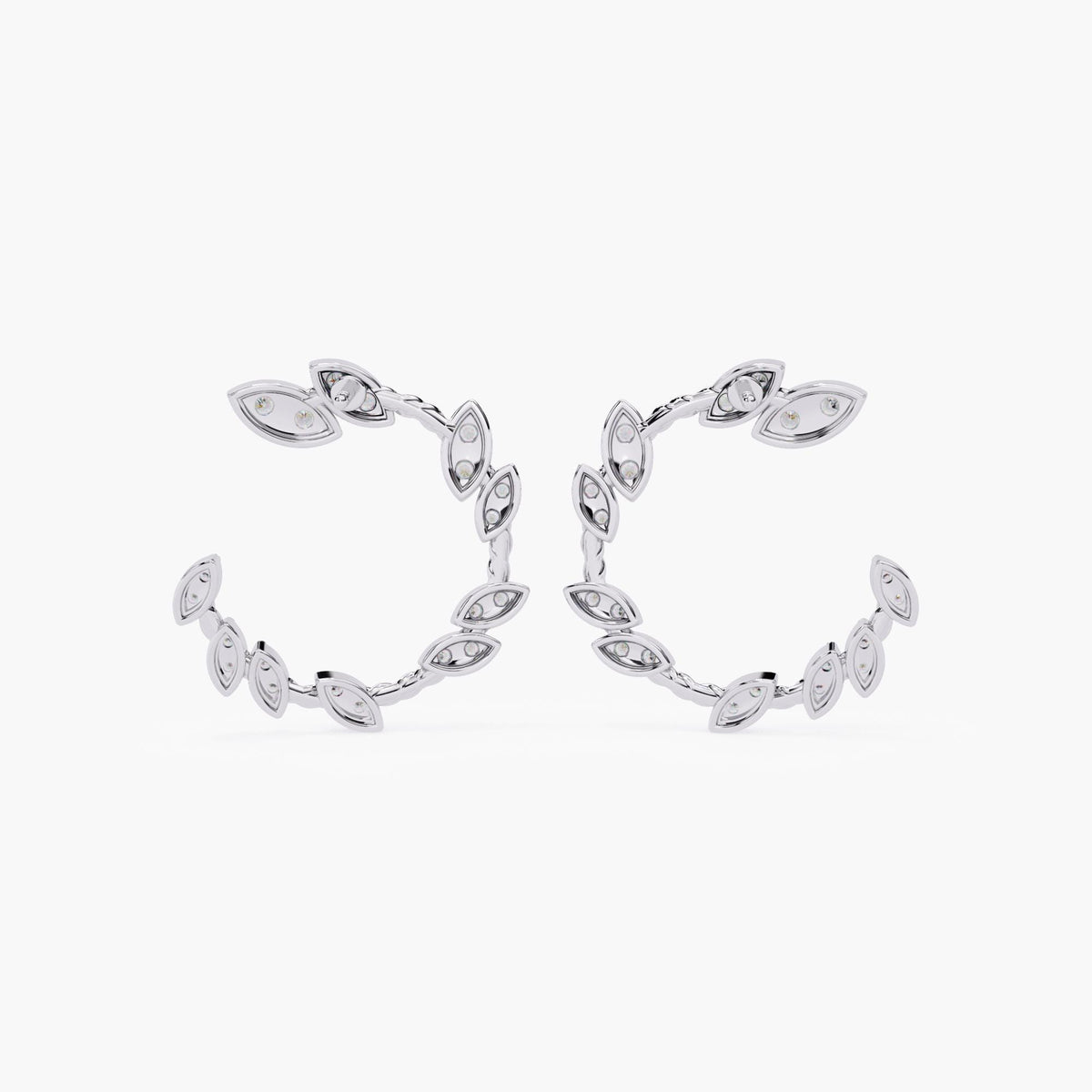A pair of white gold earrings with marquise cut diamonds.