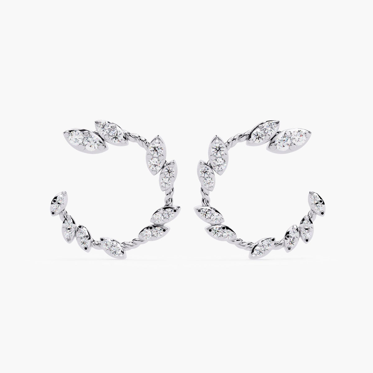 A pair of white gold earrings with marquise cut diamonds.