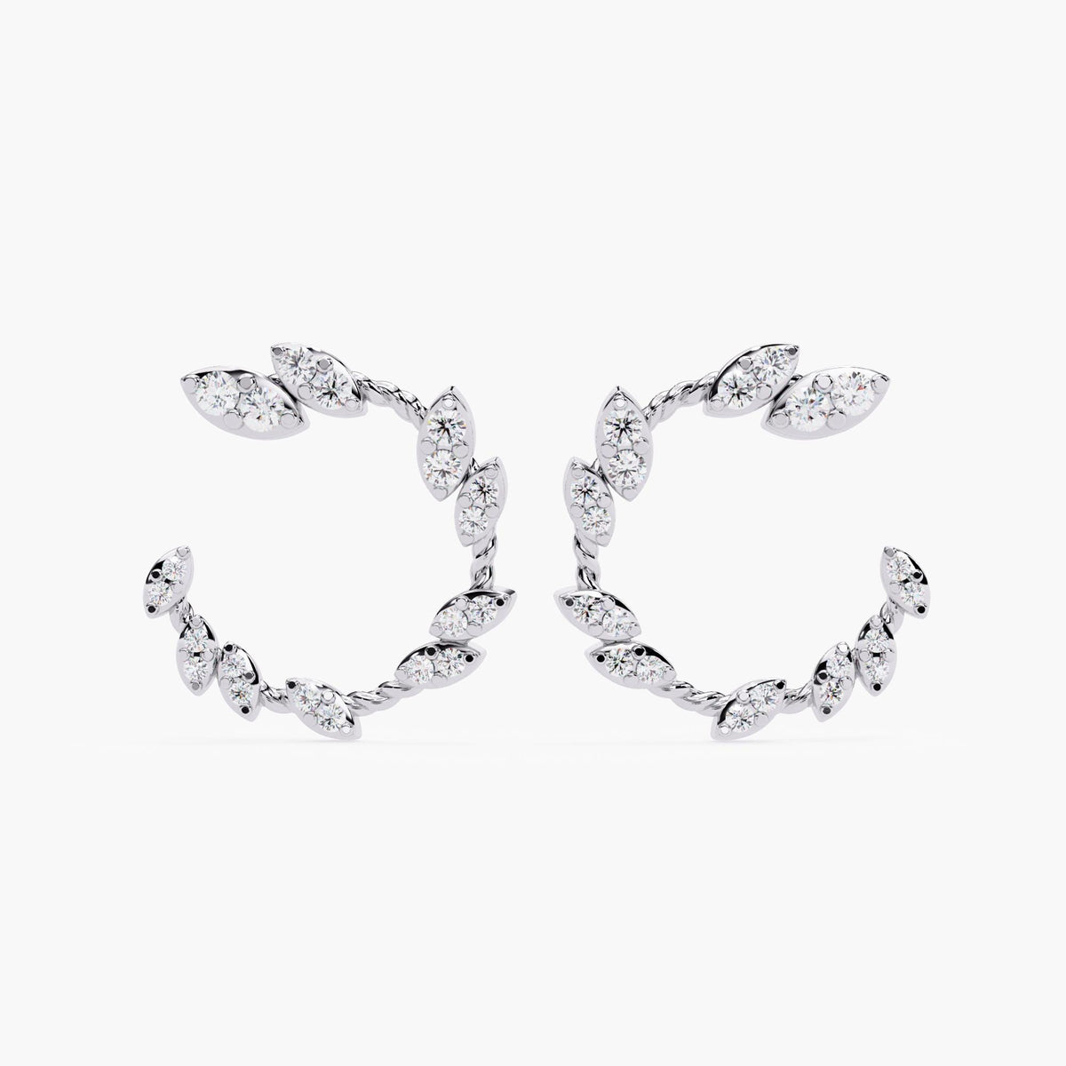 A pair of white gold earrings with marquise cut diamonds.