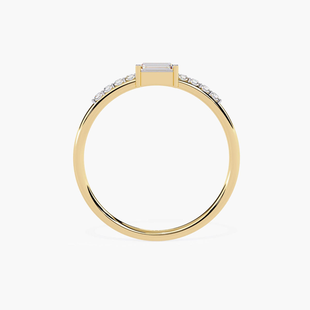 A thin yellow gold band with a small rectangular diamond in the center and smaller round diamonds on either side of the center stone.