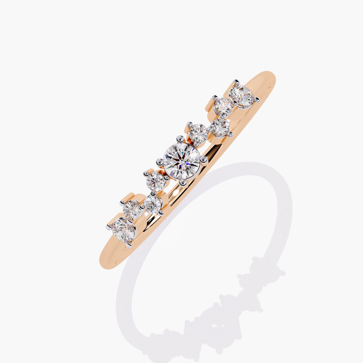 A rose gold band ring with a cluster of small diamonds and a larger round diamond in the center.