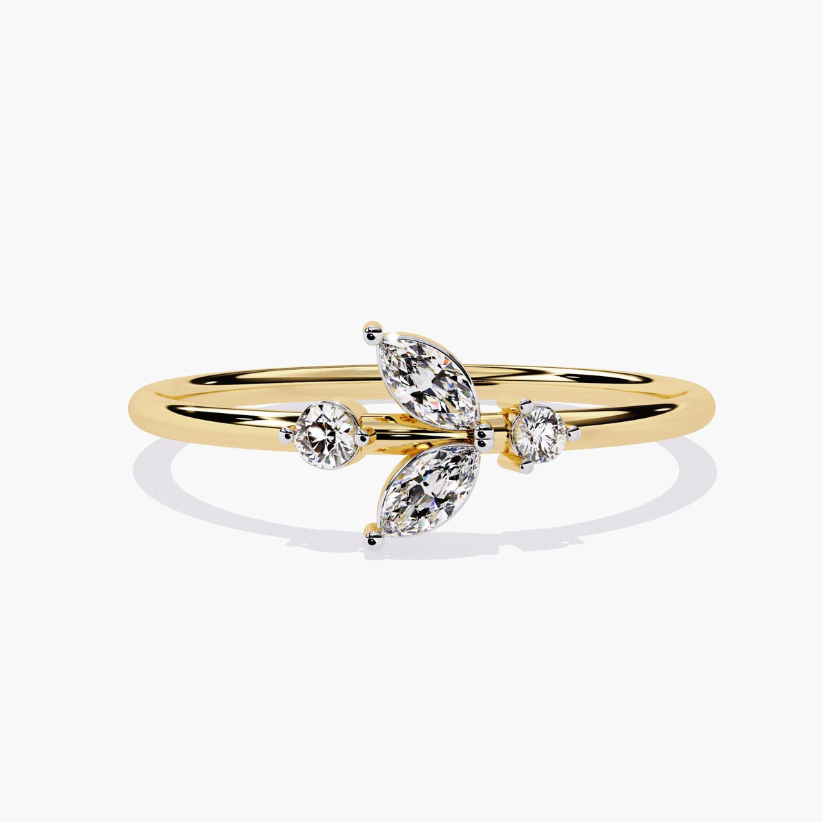 A yellow gold ring with a delicate leaf design featuring marquise-shaped diamonds and two round diamonds.