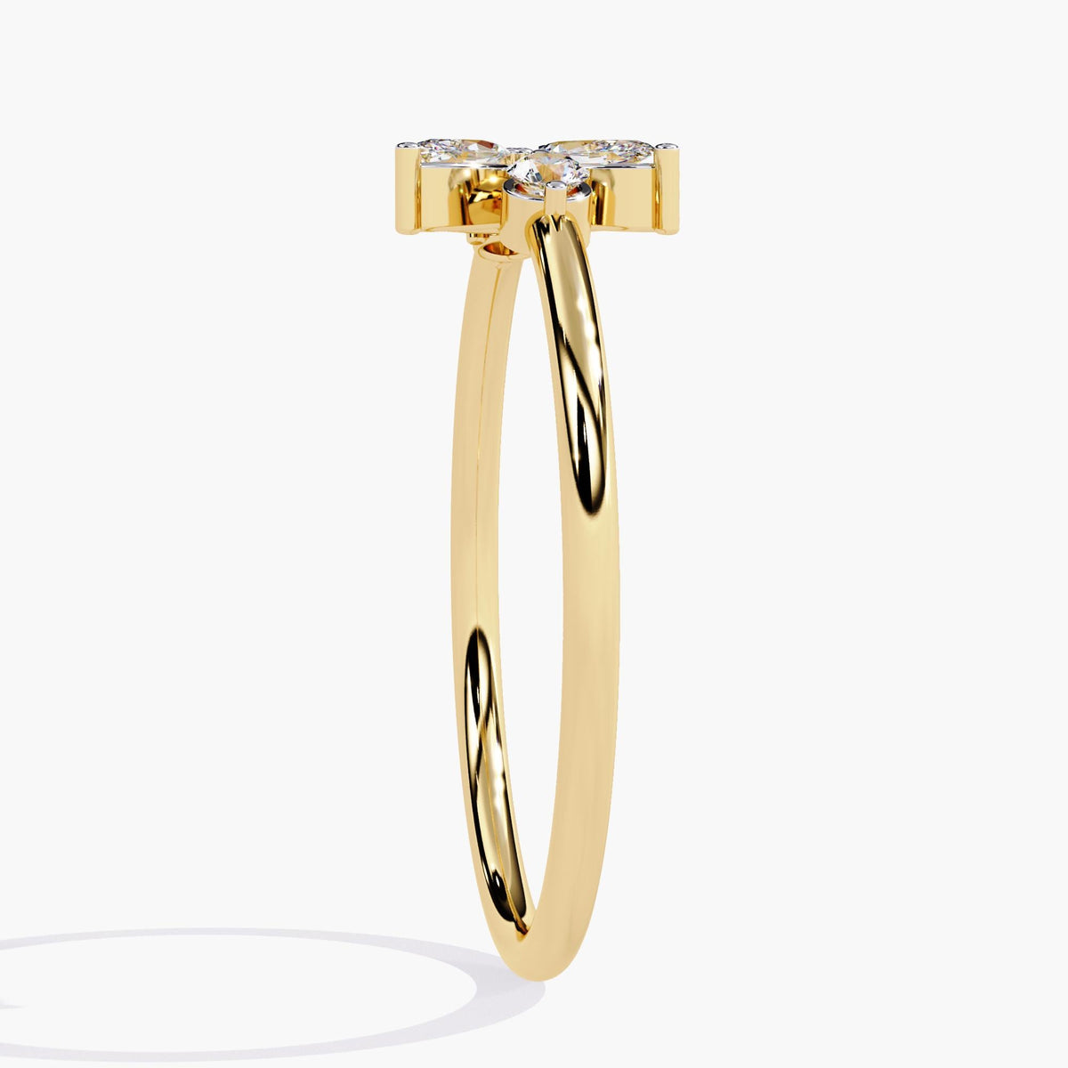 A yellow gold ring with a delicate leaf design featuring marquise-shaped diamonds and two round diamonds.