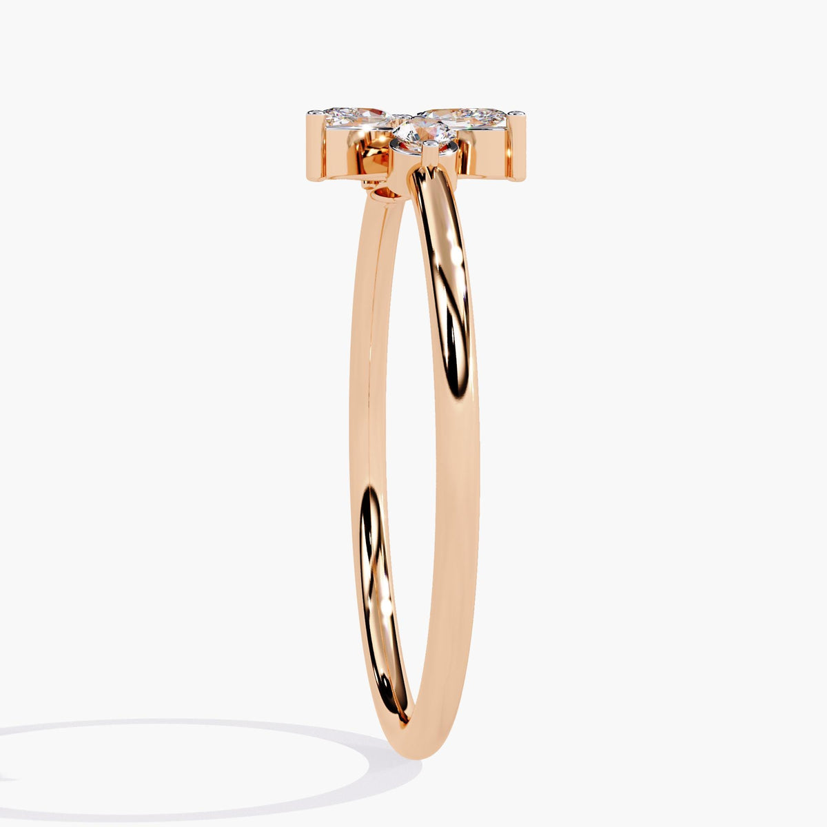 A rose gold ring with a delicate leaf design featuring marquise-shaped diamonds and two round diamonds.