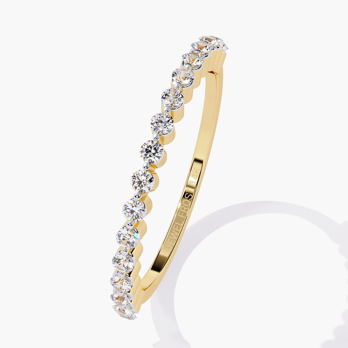 Angled top-down view of a half eternity diamond ring in 14k yellow gold with round lab-grown diamonds set in a floating single prong design. The ultra-thin band highlights maximum sparkle and features the Jewel Frost engraving inside—perfect for stacking or minimalist bridal wear.