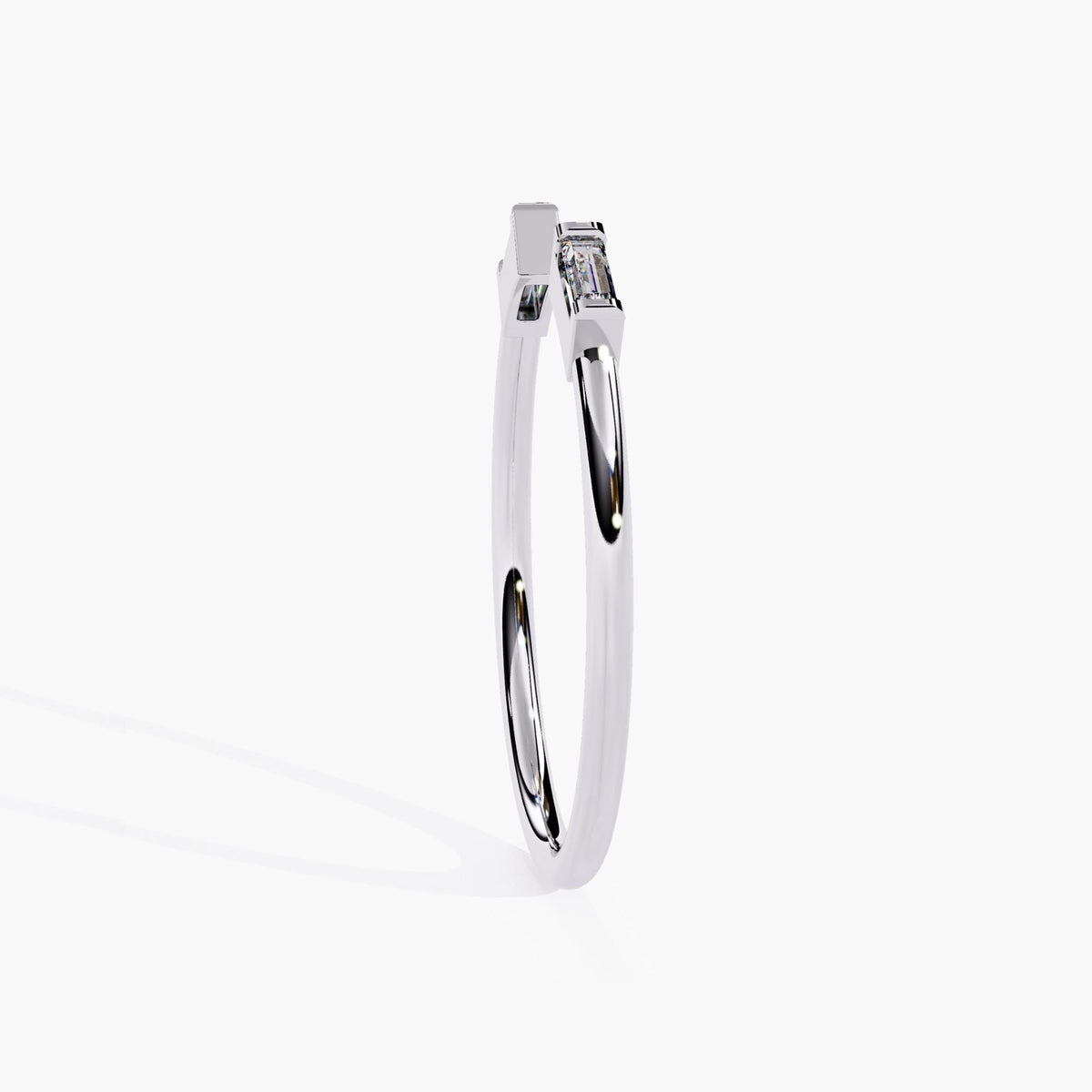 Side profile of a 14k white gold open ring with two baguette diamonds bezel set at the open ends, showing the straight band and east-west baguette diamond orientation.