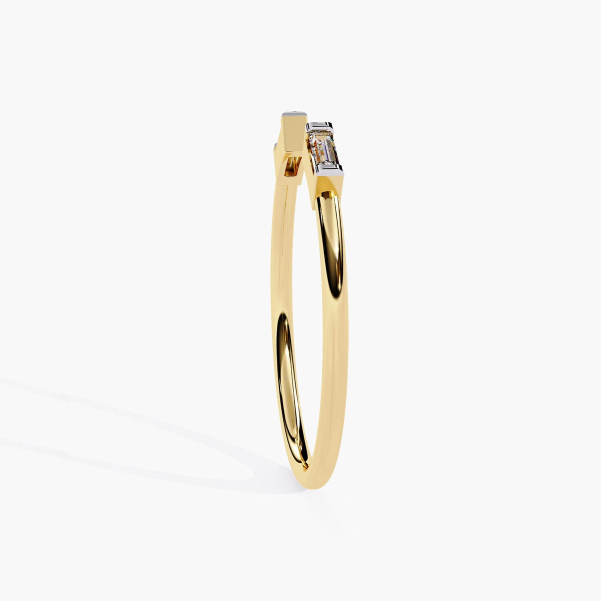 Slim side profile of a 14K yellow gold open band ring with two baguette-cut natural diamonds mounted in geometric prong settings. The sleek form makes it a versatile stacking ring or a subtle everyday piece.