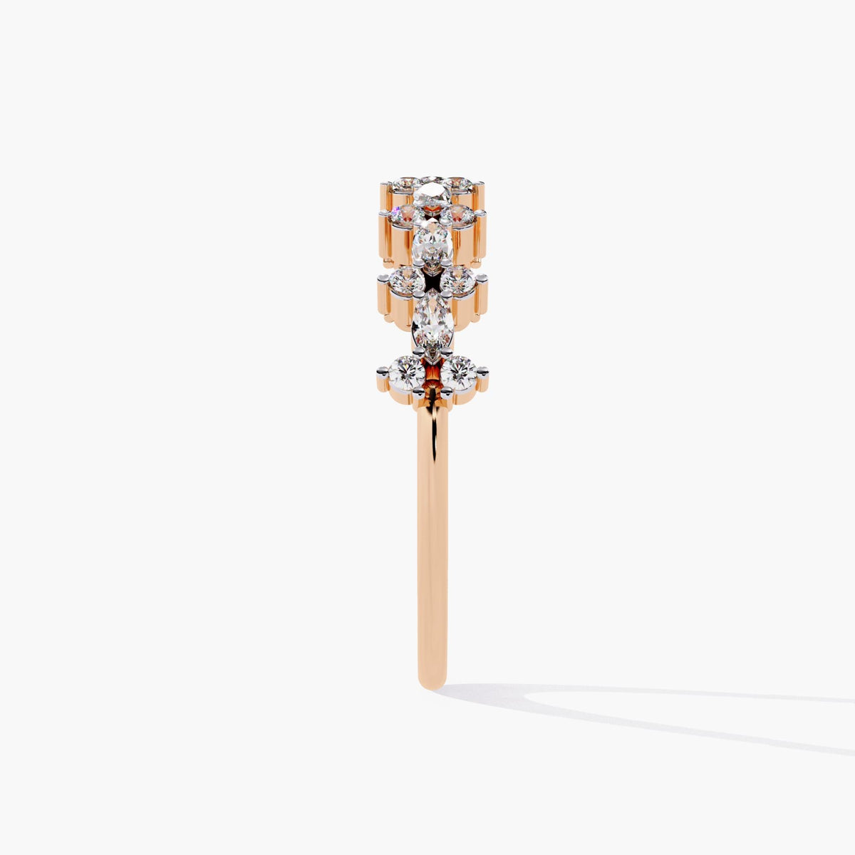 Side profile of a 14k rose gold diamond ring showing the height and structure of east-west marquise and round diamond clusters along the band.