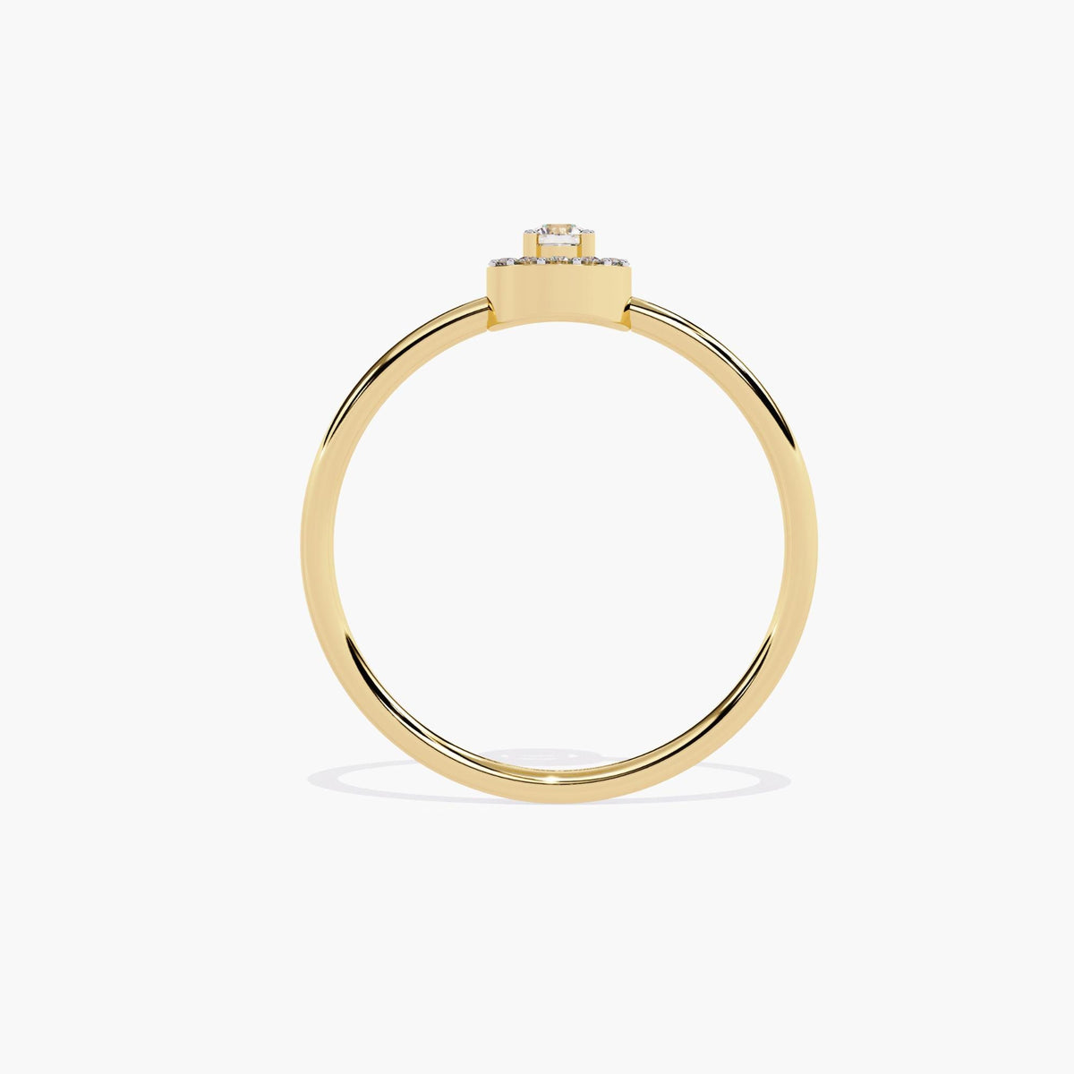 A yellow gold band ring with a single round diamond set in a halo of smaller diamonds.