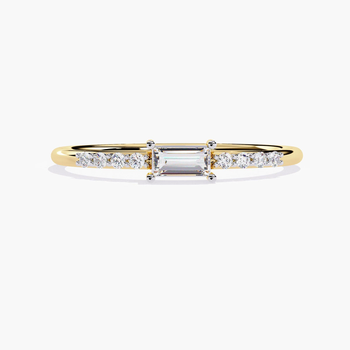 A thin yellow gold band with a small rectangular diamond in the center and smaller round diamonds on either side of the center stone.