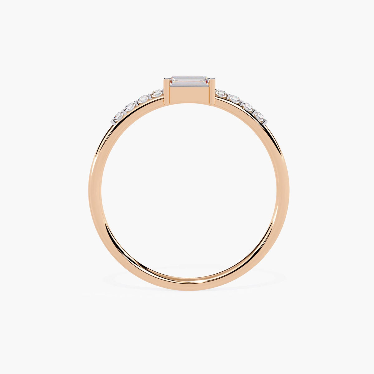 A thin rose gold band with a small rectangular diamond in the center and smaller round diamonds on either side of the center stone.