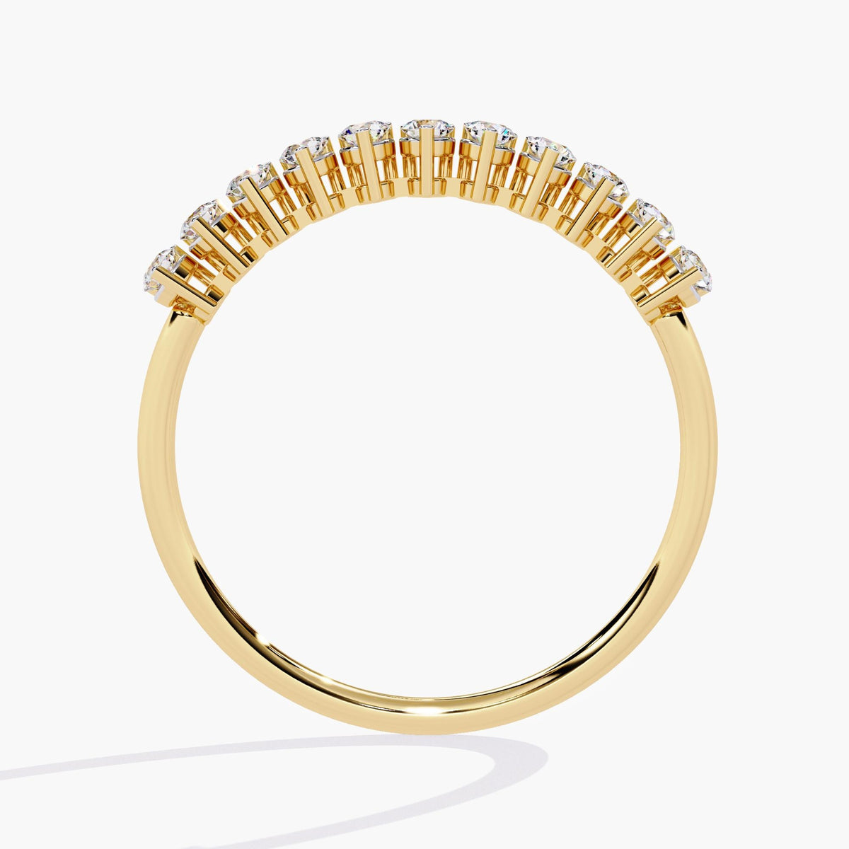 A yellow gold half eternity band with a row of small, round, clear diamonds.