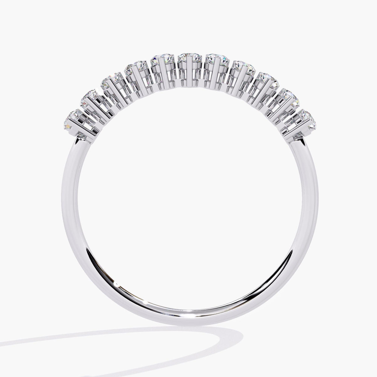 A white gold half eternity band with a row of small, round, clear diamonds.