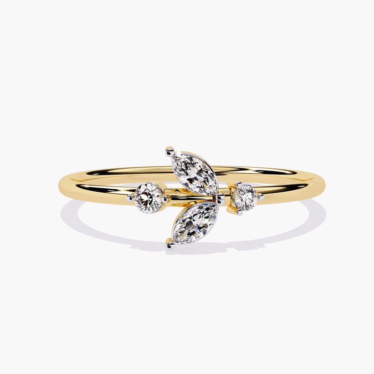 A yellow gold ring with a delicate leaf design featuring marquise-shaped diamonds and two round diamonds.