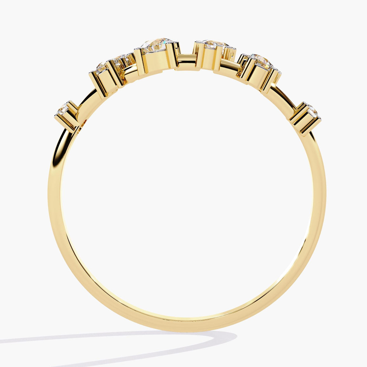 A yellow gold band with alternating round-cut diamonds set in a delicate open-band arrangement.
