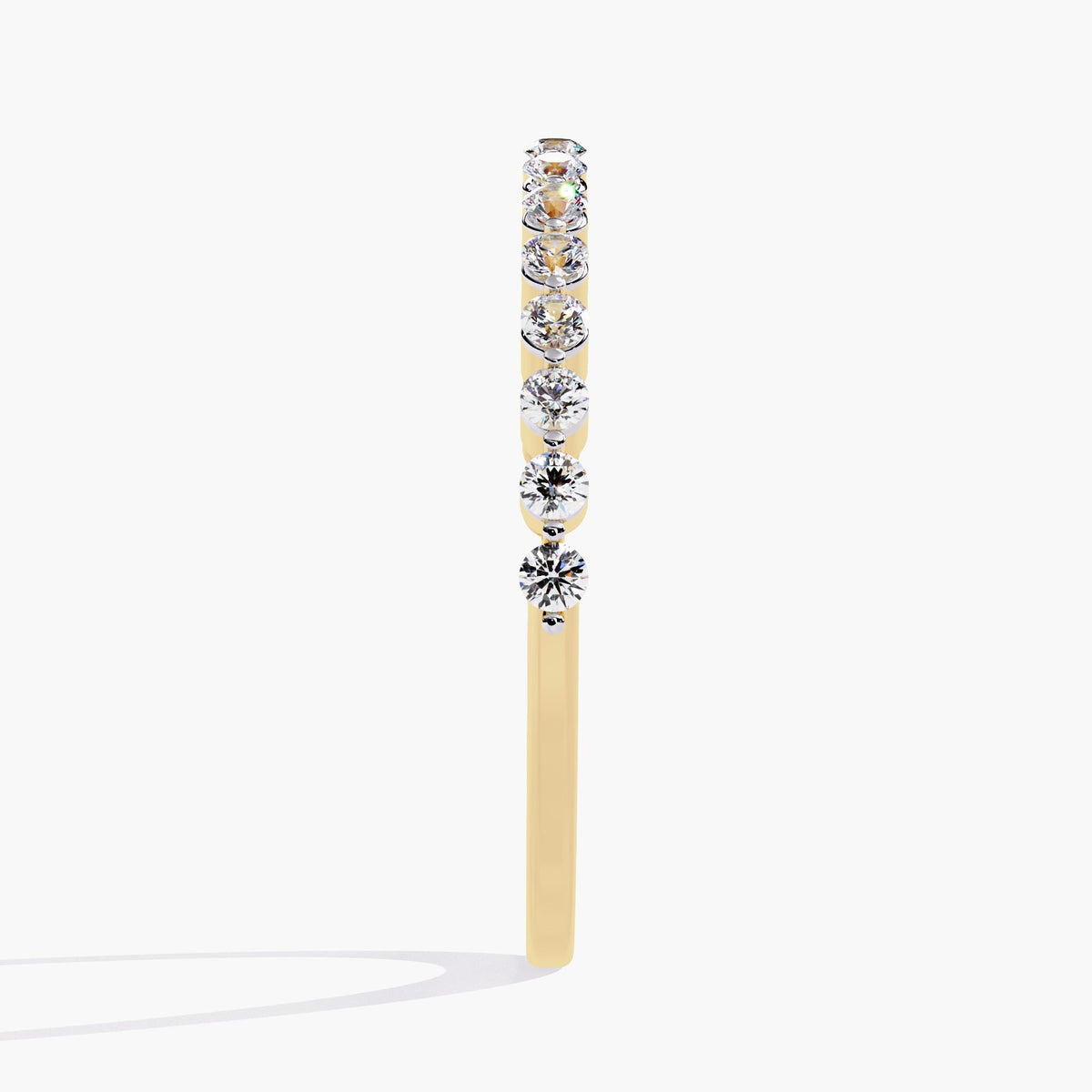 14k yellow gold single prong diamond band, showing the full row of round natural diamonds in a clean, shared prong setting. The slim band and minimal metal make the diamonds appear to float in a delicate line.