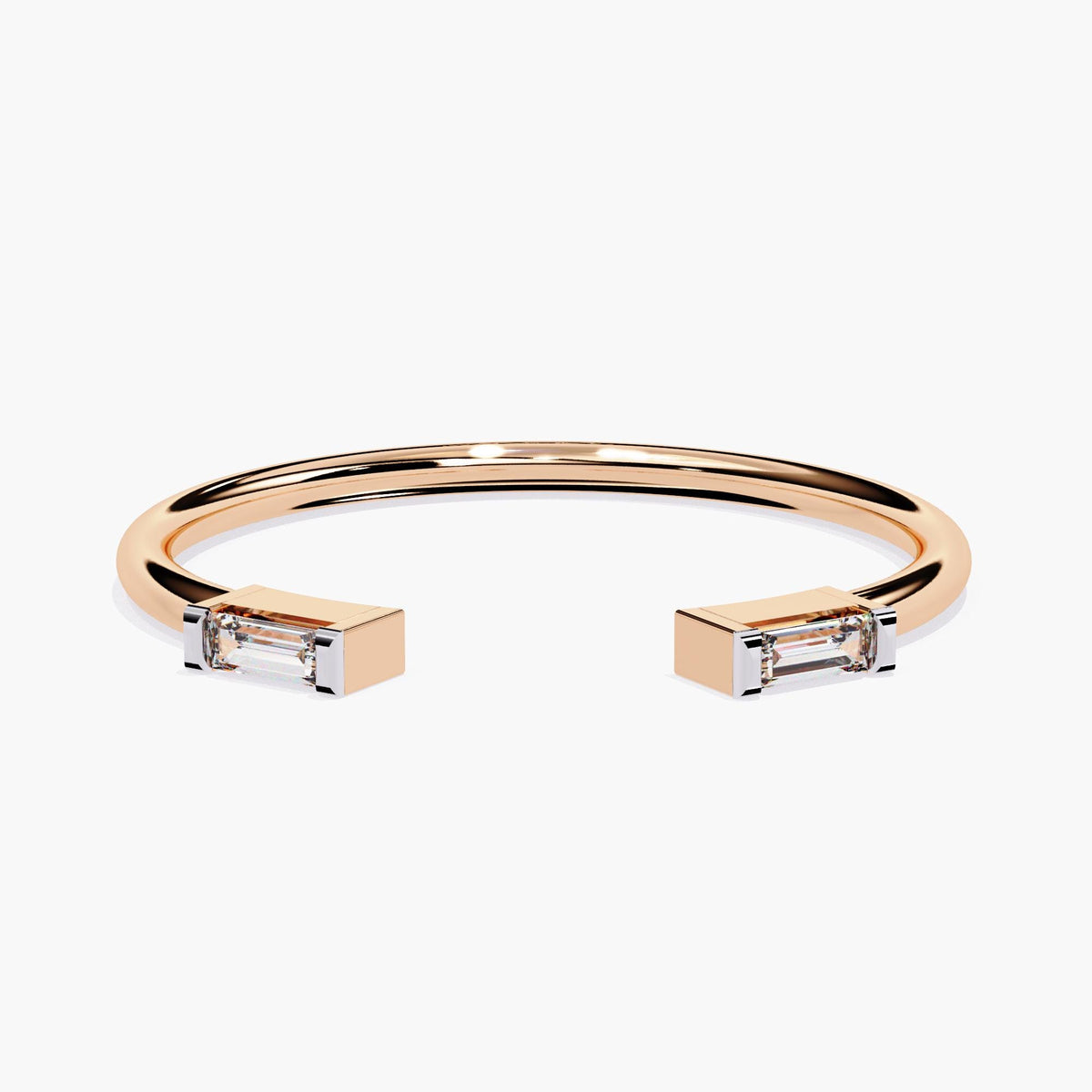 Angled view of a 14K rose gold open band ring with two horizontally set baguette-cut diamonds in squared prong settings. This dainty cuff ring is well suited for minimalist engagement looks or everyday fine jewelry.