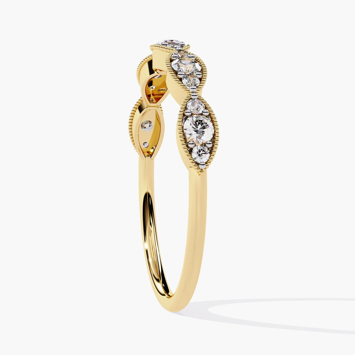 Angled side view of a 14k yellow gold ring showing five raised marquise-shaped bezels, each holding three round lab-grown diamonds. The band tapers gently underneath for a lighter, airy feel. A balanced piece suited for minimalist engagement or fine stacking jewelry.