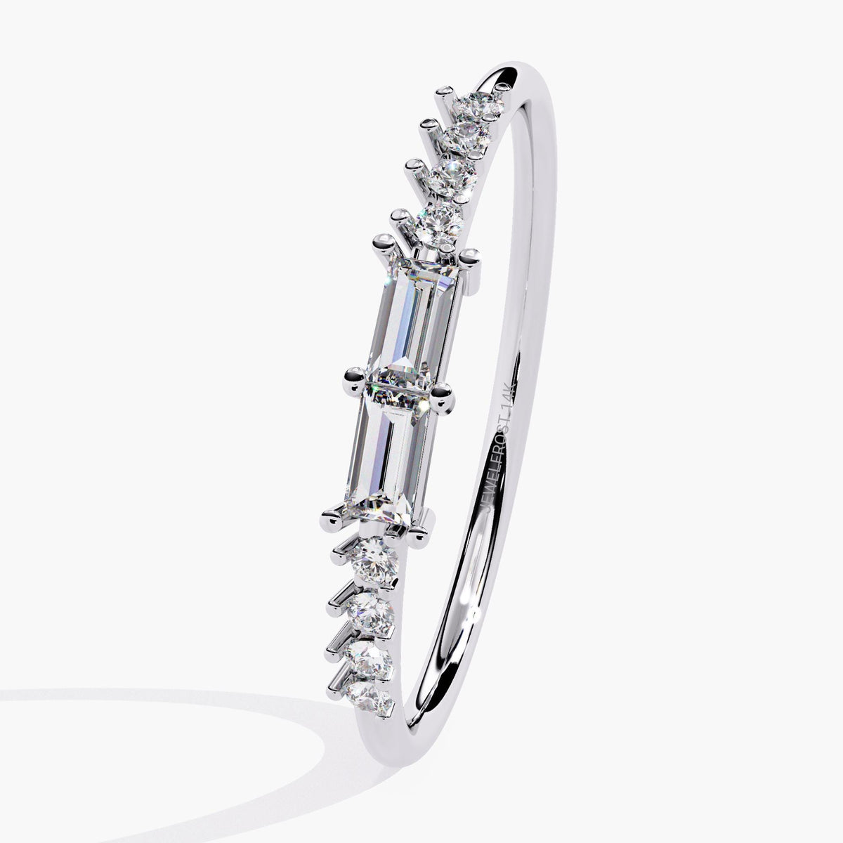 A white gold band ring with a baguette diamond and smaller round diamonds on the band.
