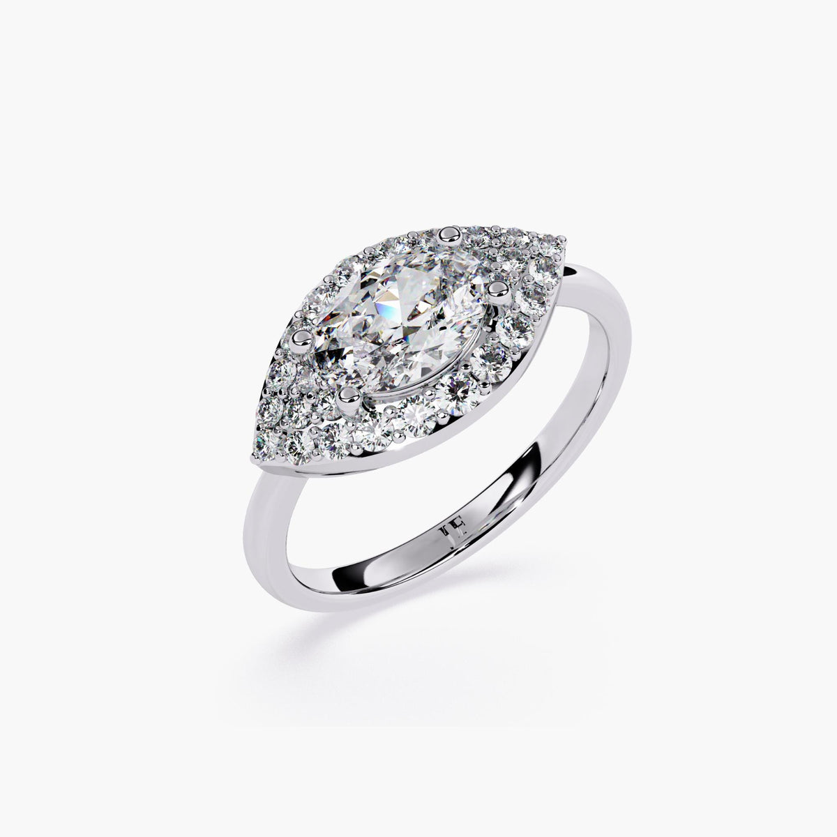A white gold engagement ring with a marquise cut diamond center stone and a halo of smaller diamonds.