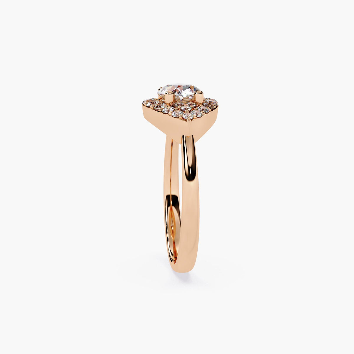 A rose gold engagement ring with a marquise cut diamond center stone and a halo of smaller diamonds.