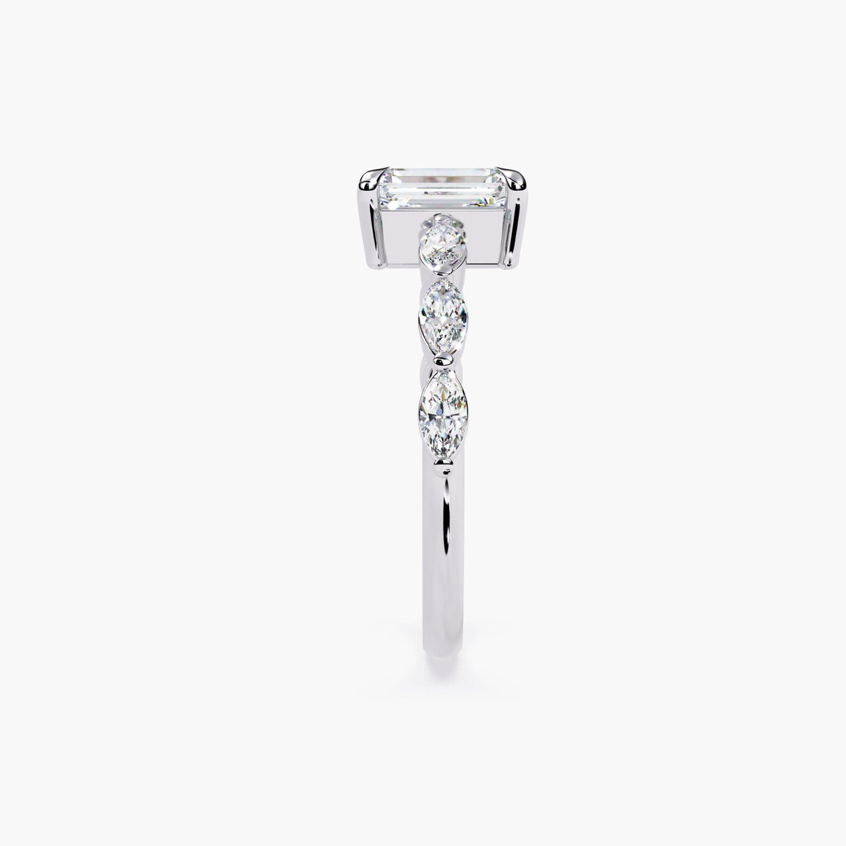 A gold emerald-cut moissanite engagement ring. The ring features a large, radiant emerald-cut moissanite center stone.