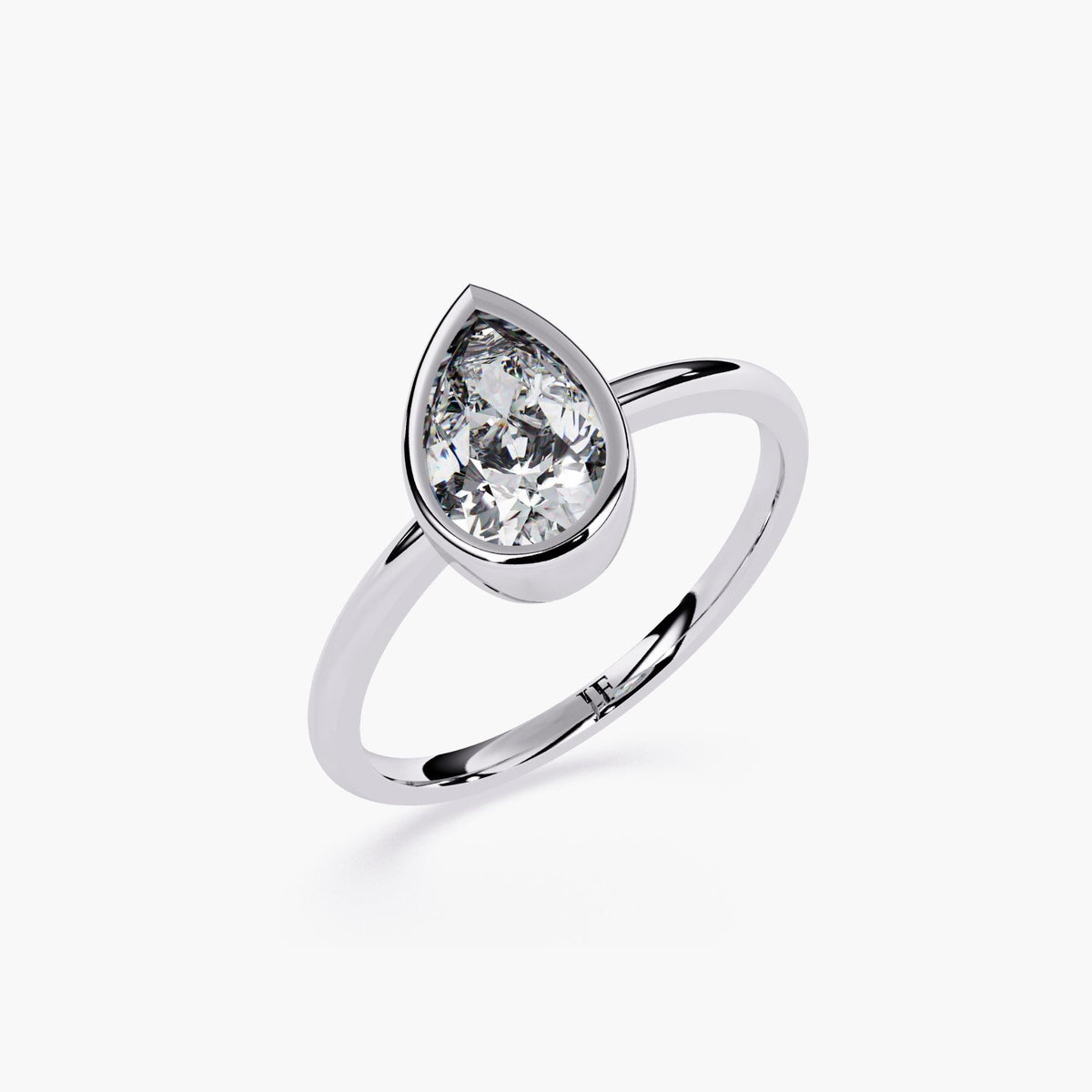 A white gold ring with pear cut diamond at the center.