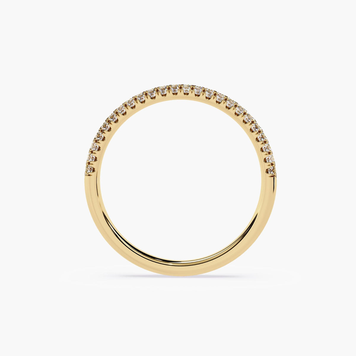 A yellow gold band featuring a row of small, clear diamonds set around half of the band.