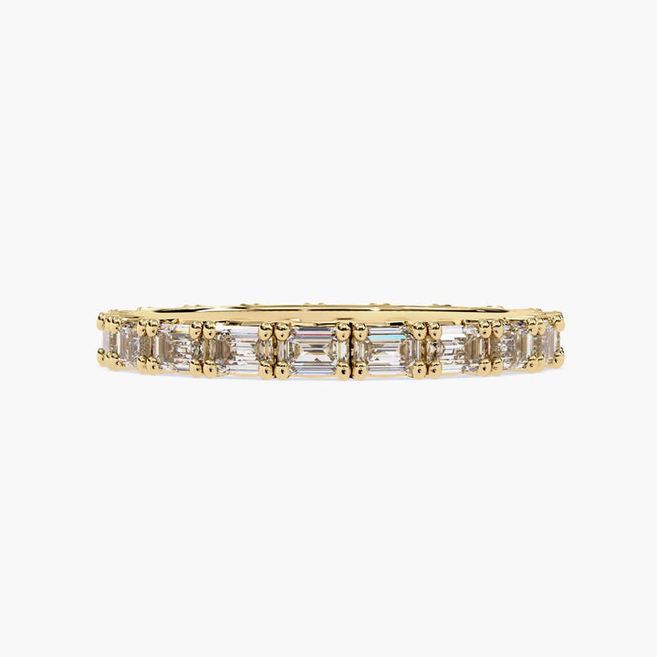 A gold band with a row of emerald cut diamonds.