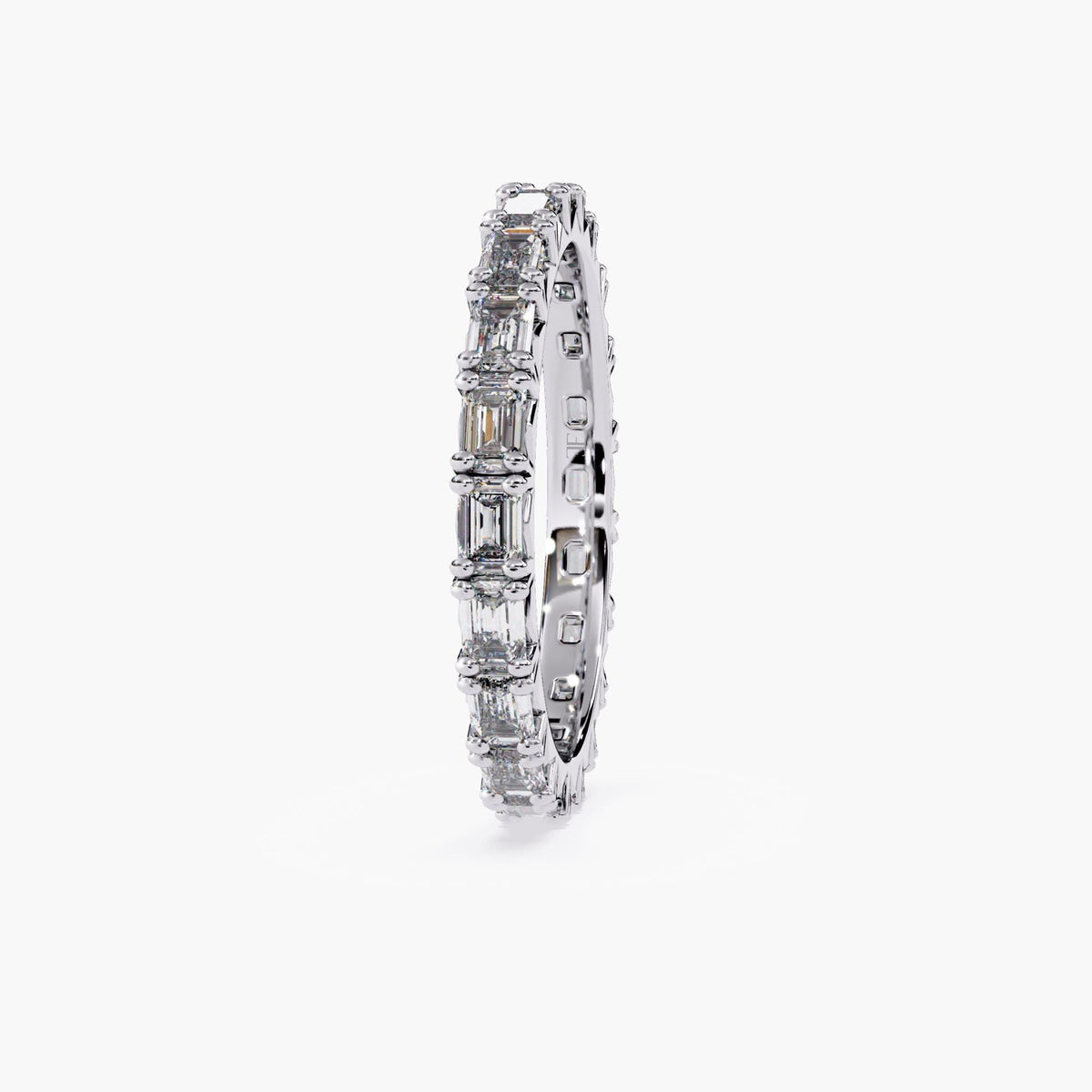 A white gold band with a row of emerald cut diamonds.