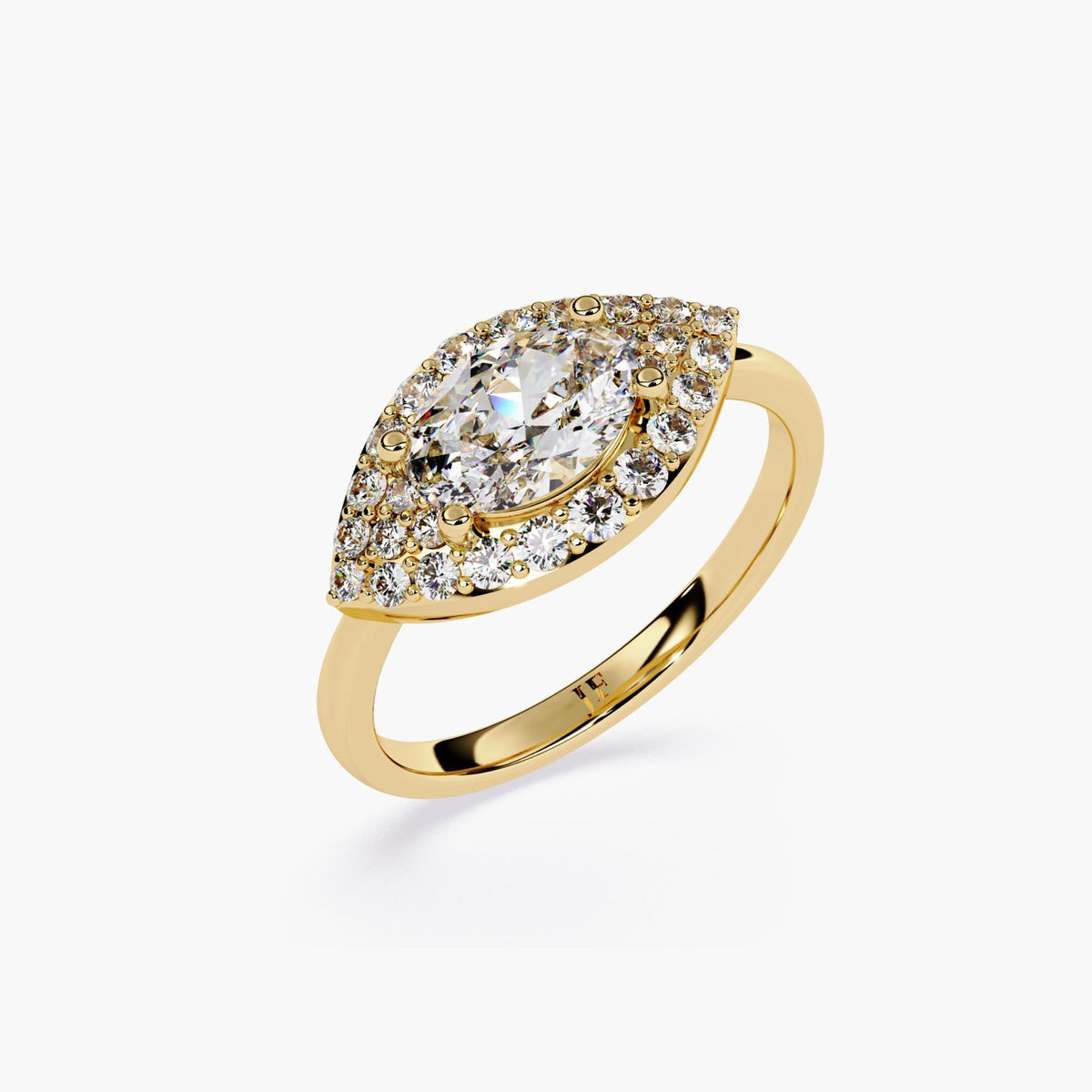 A gold engagement ring with a marquise cut diamond center stone and a halo of smaller diamonds.