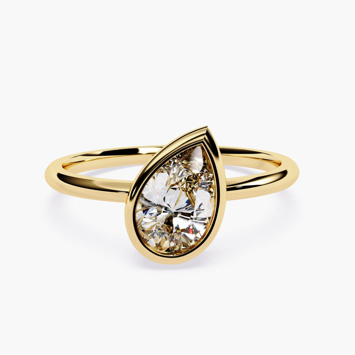 A gold ring with pear cut diamond at the center.
