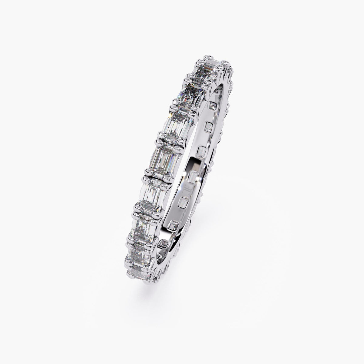 A white gold band with a row of emerald cut diamonds.