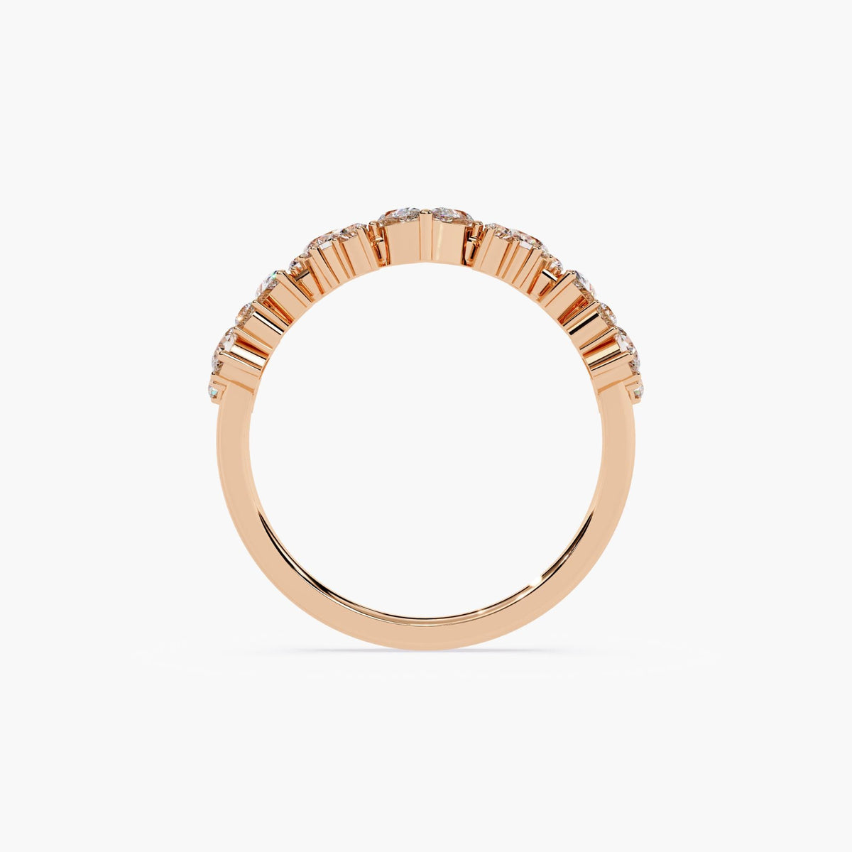A curved rose gold half eternity ring with marquise and round shaped diamonds.
