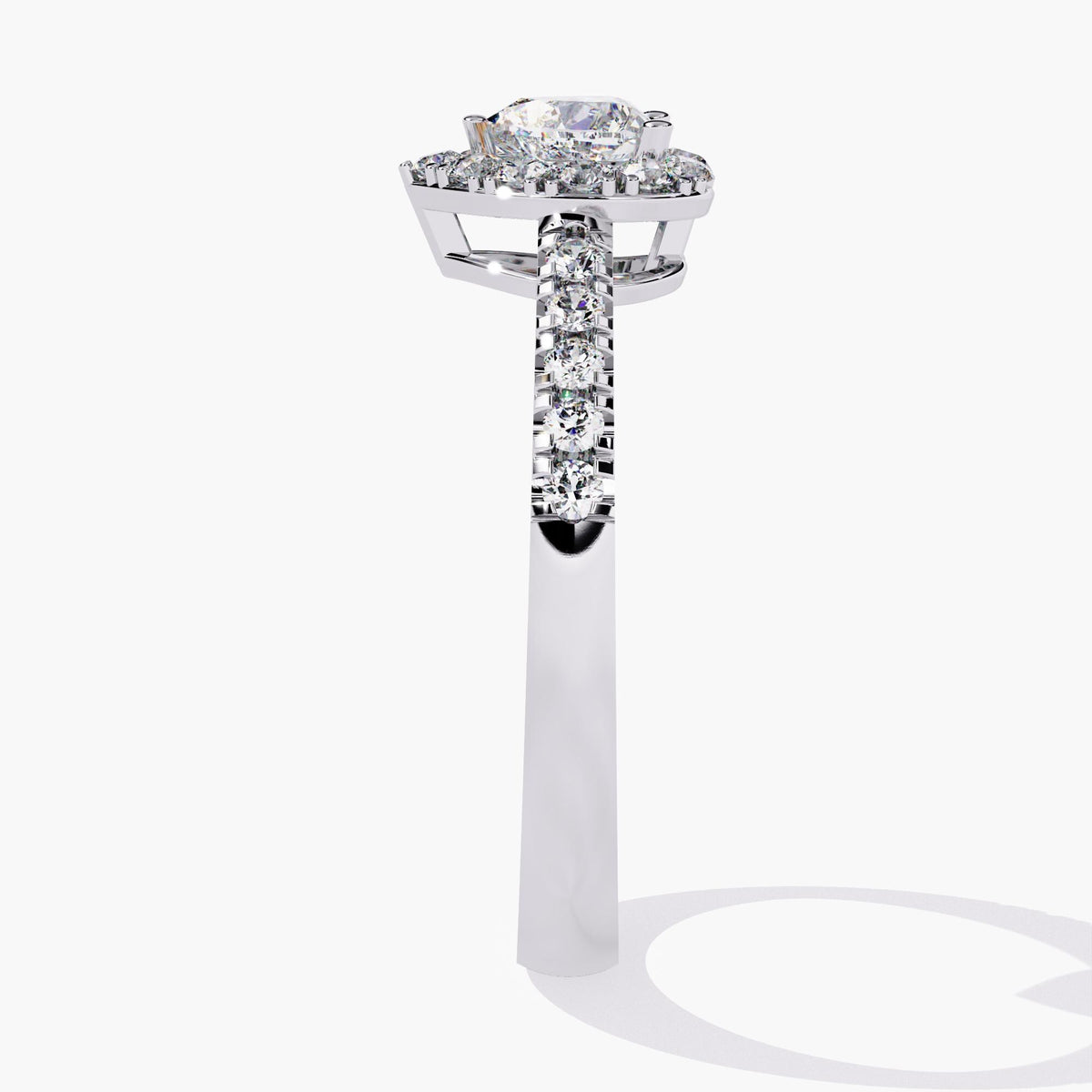 A heart-shaped diamond engagement ring with a halo setting and a white gold band.