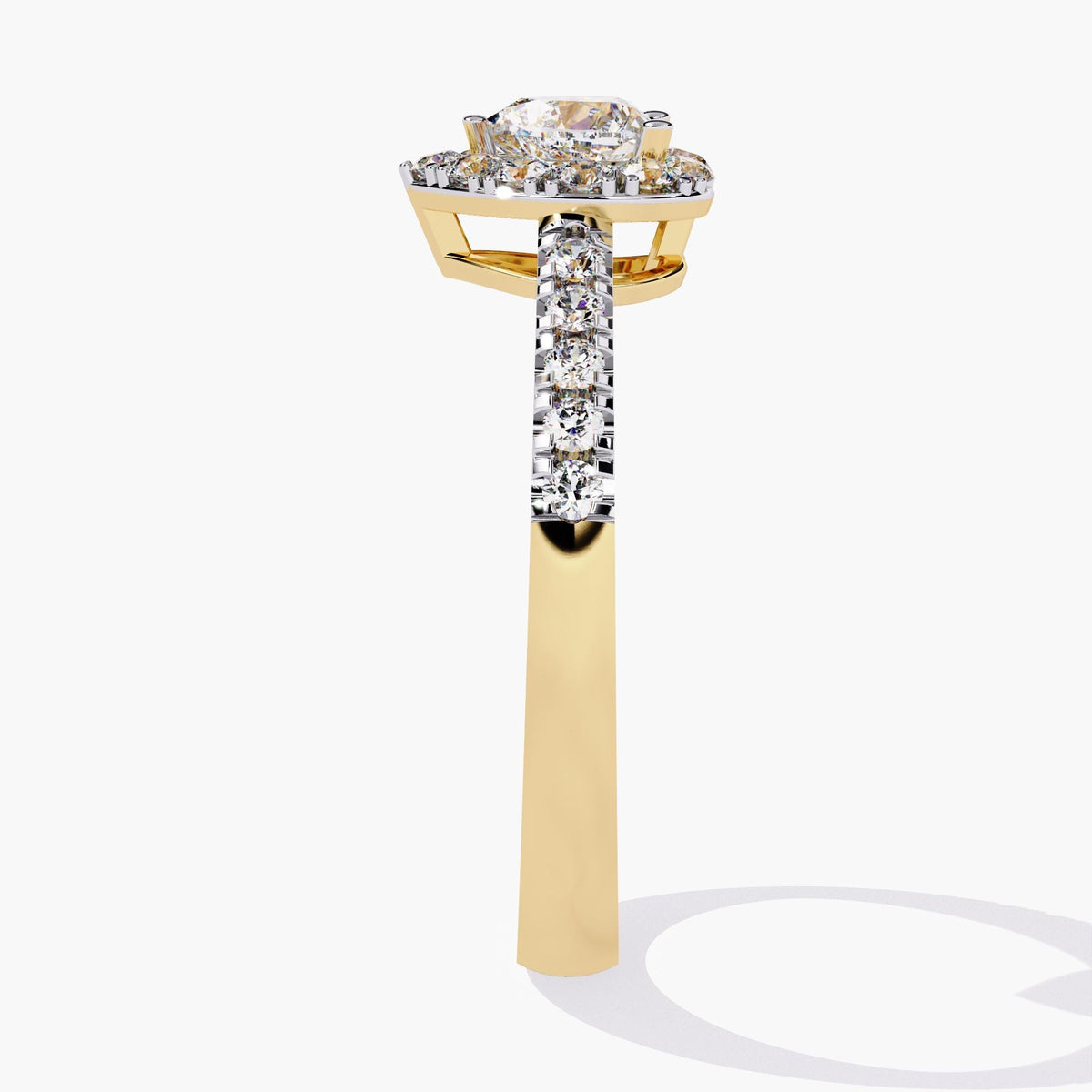 A heart-shaped diamond engagement ring with a halo setting and a gold band. the shank has graduating diamonds. the ring is medium profile making it excellent to stack with other wedding bands