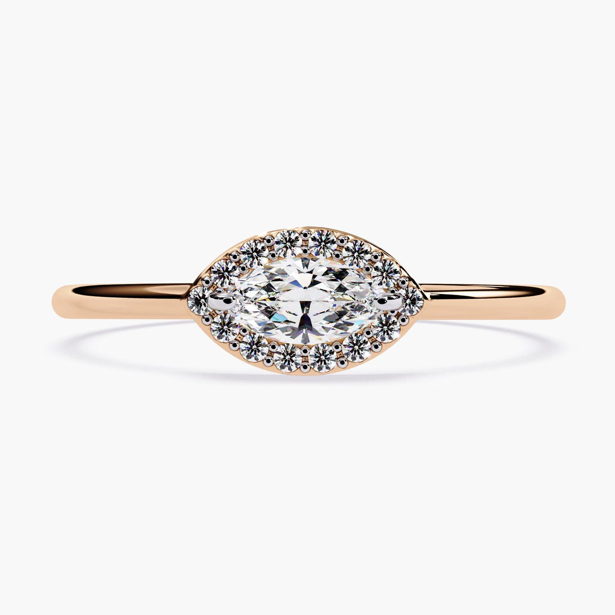 a rose gold marquise halo ring showcasing a 6x3mm marquise-cut diamond set east-west, surrounded by a frame of tiny round natural diamonds. The sleek rose gold band adds warmth to this dainty, feminine engagement or promise ring design.