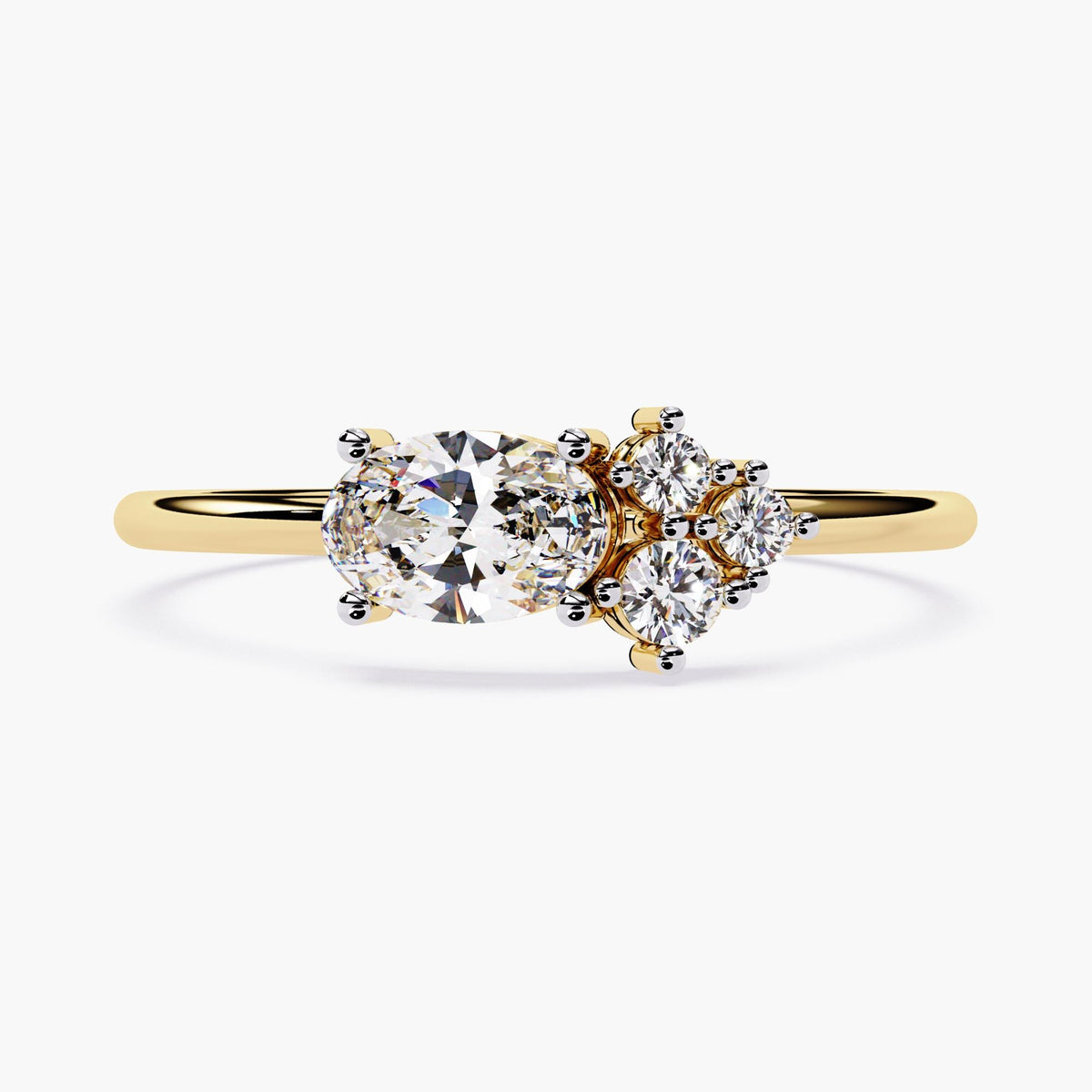 14k yellow gold ring featuring a 0.30ct oval natural diamond in an east-west setting, accented with a floral-inspired cluster of round diamonds on one side. A dainty, asymmetrical design perfect for engagement, promise, or gift rings.