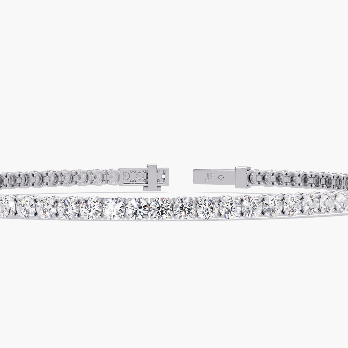 Close-up view of a white gold diamond tennis bracelet with round cut natural diamonds in a four-prong setting. The secure clasp is shown open and safety latch detail. The bracelet features a continuous row of sparkling diamonds.
