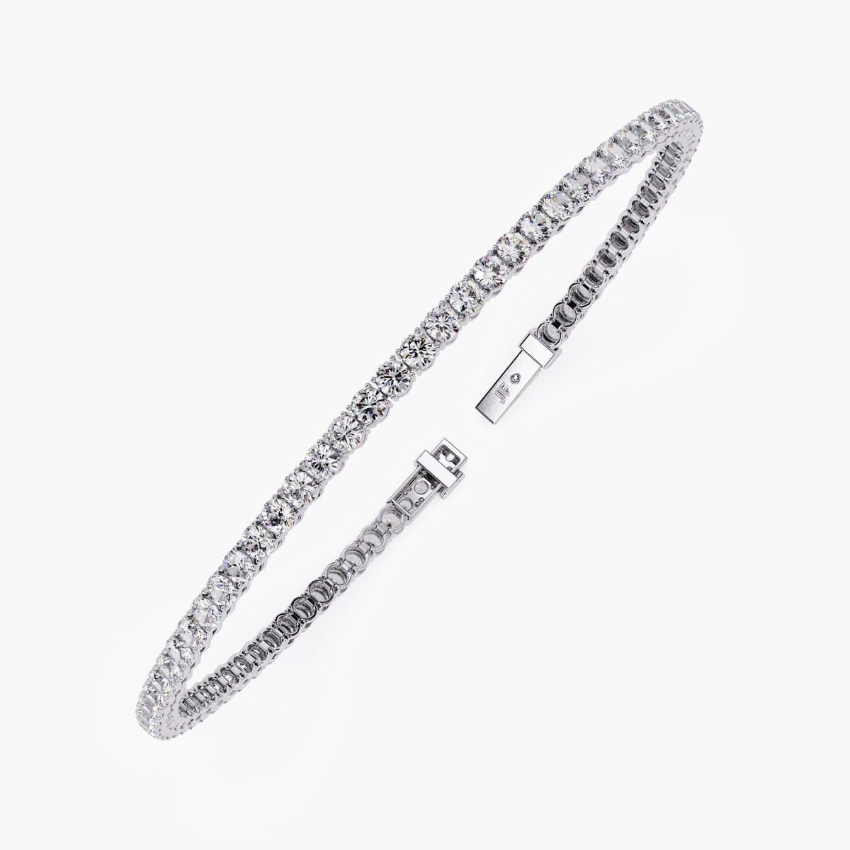 Full view of a white gold diamond tennis bracelet laid in a curved shape. The round natural diamonds are set in a continuous line with a four-prong setting