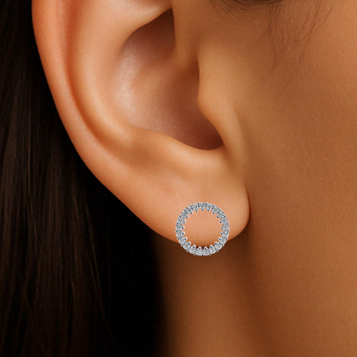 Open circle earring modeled on a ear. the circle ends slightly below the ear lobe