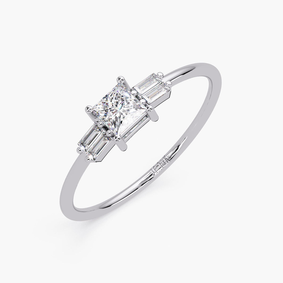 close-up of the white gold version, highlighting the sparkle of the center princess cut diamond and side baguettes.