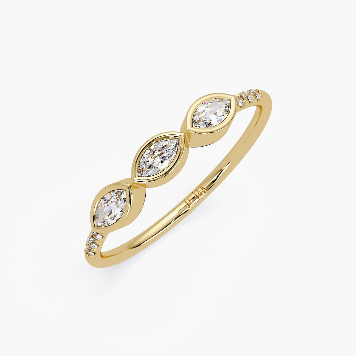 14K yellow gold band featuring three marquise diamonds set in bezel settings, with small round diamonds on the sides of the band.