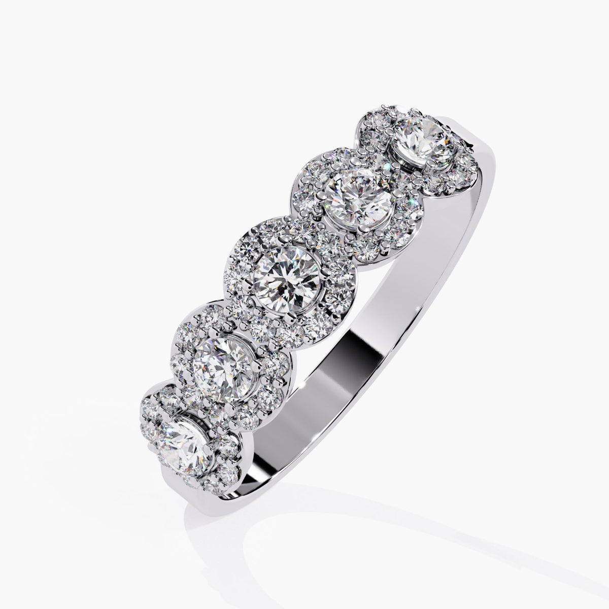 Angled view of a 14k white gold band with five round lab-grown diamonds, each encircled by a halo of smaller diamonds. The polished inner band and raised halo settings give the piece a structured, high-end feel, ideal for bridal styling or statement stacking.
