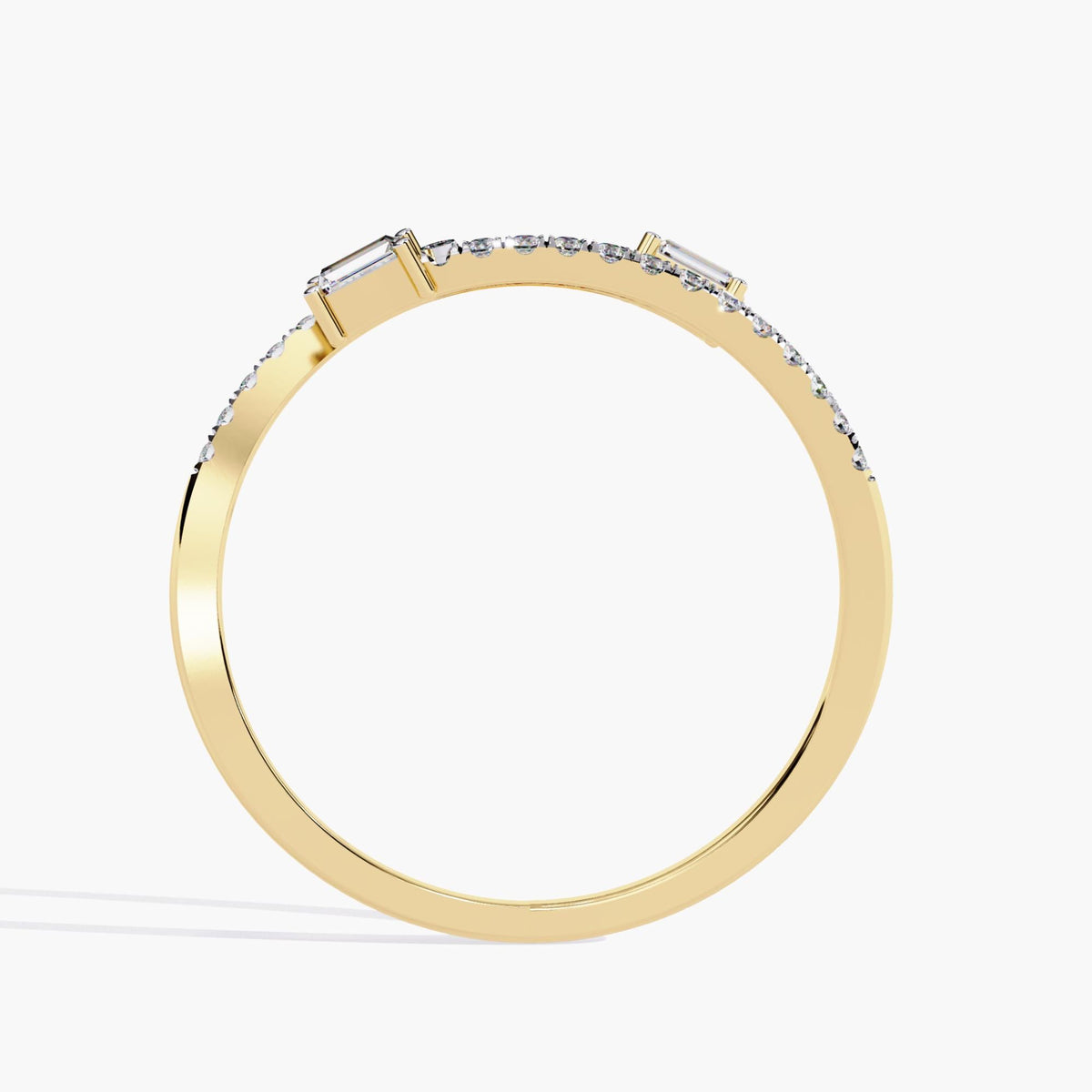 Side profile of a 14k yellow gold open bypass ring showing a smooth high-polish band with pavé-set diamonds and two east-west baguette diamonds at the ends.
The minimal profile keeps the focus on the clean geometry and low setting height.
Designed to sit flush against other stackable bands or wear alone.