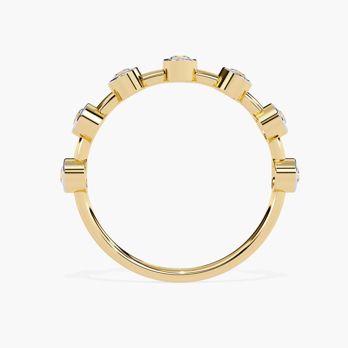 "A side view of a yellow gold stacking ring with round diamonds set in polished bezel settings. The diamonds are evenly spaced around the band, offering a clean and modern look. The simple design of the bezel settings adds a sophisticated touch, making it perfect for stacking with other rings or wearing on its own as a minimalist statement piece.