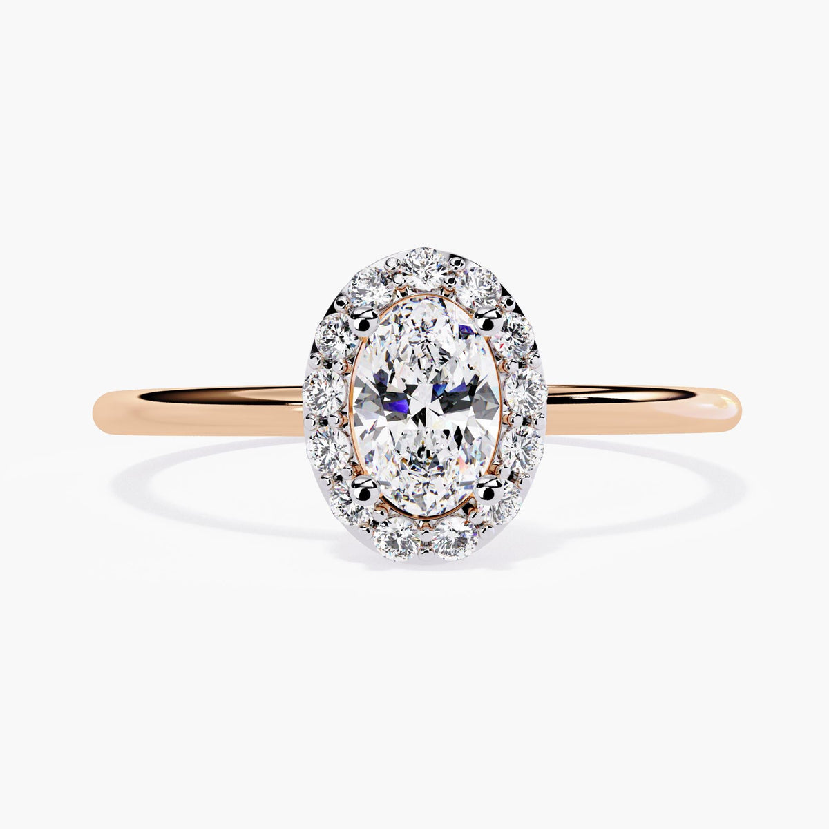 14k rose gold oval halo engagement ring featuring a 0.35 ct center lab diamond surrounded by a halo of round diamonds. The thin, polished rose gold band adds warmth and contrast to the brilliant white stones.