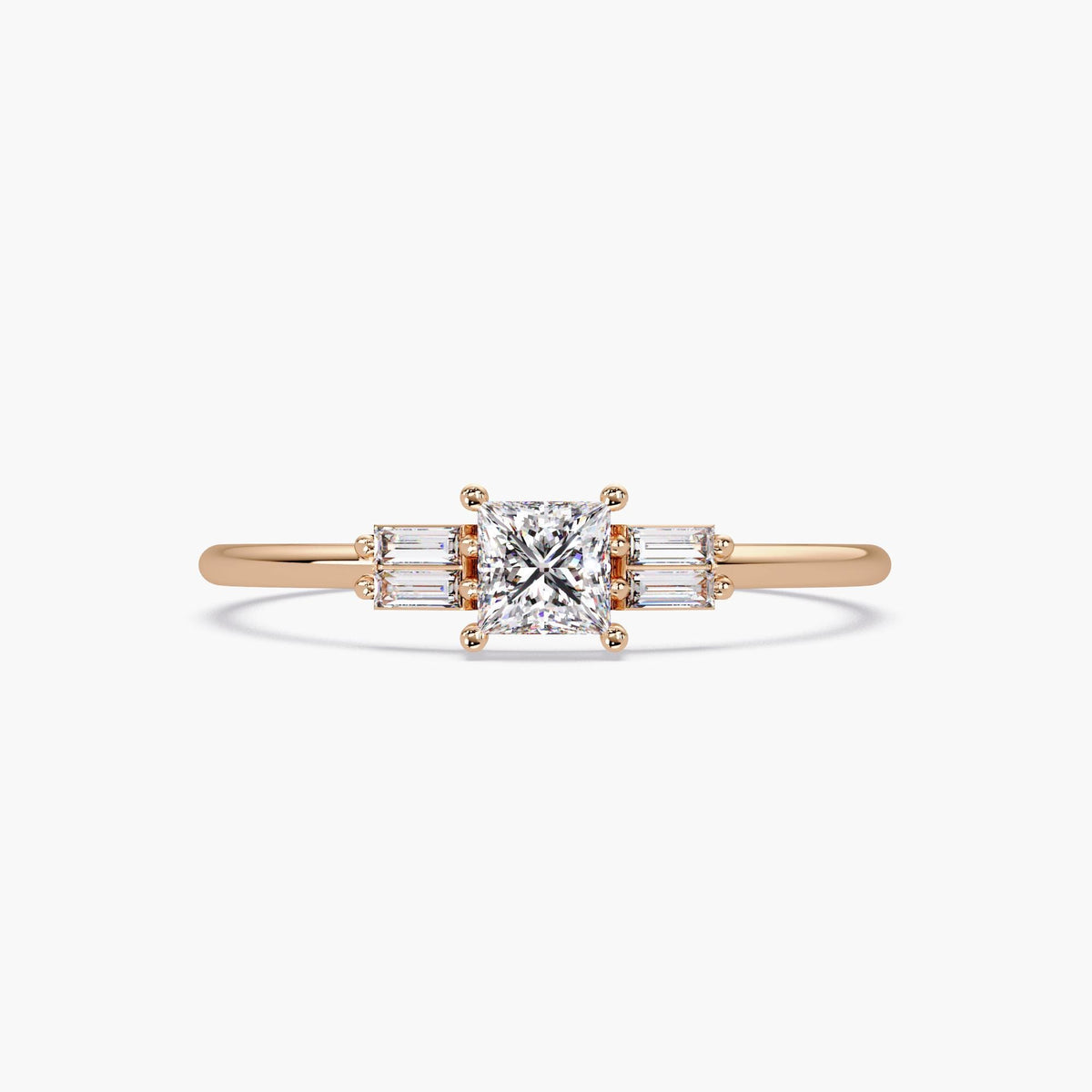 rose gold princess cut diamond ring with baguette side stones.