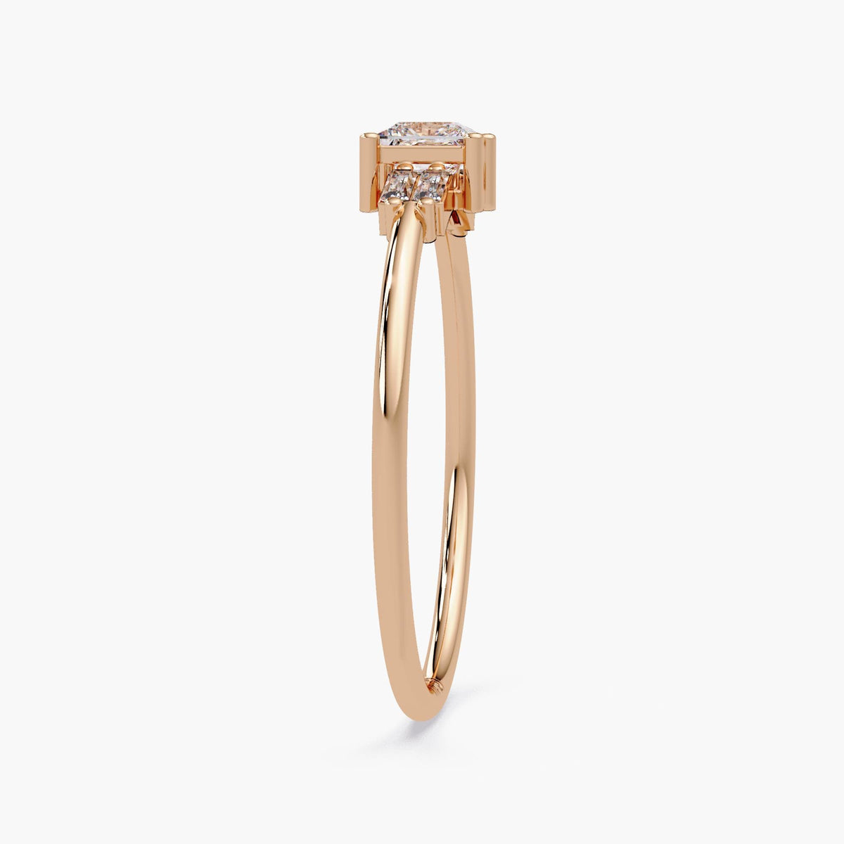 Profile view of the rose gold ring, showing the elevated princess cut diamond and slim band.