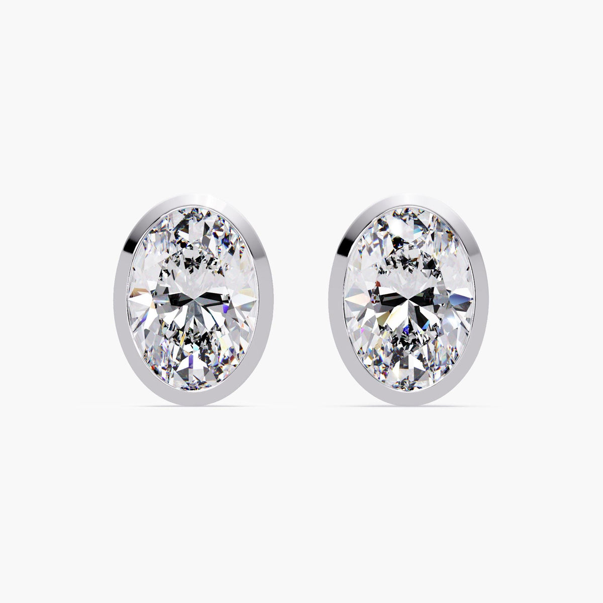 14k white gold bezel set oval diamond stud earring, showcasing the low-profile open gallery and straight pushback post. Designed for secure and comfortable everyday wear.